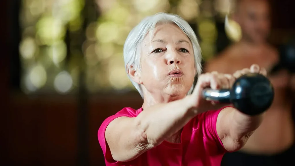 Toning Arms Without the Bulk: Is It Achievable? 1 Woman doing resistance band exercises for toned arms Wales